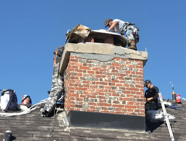 Central Falls Chimney Sweep installing a custom chimney crown in Central Falls, RI