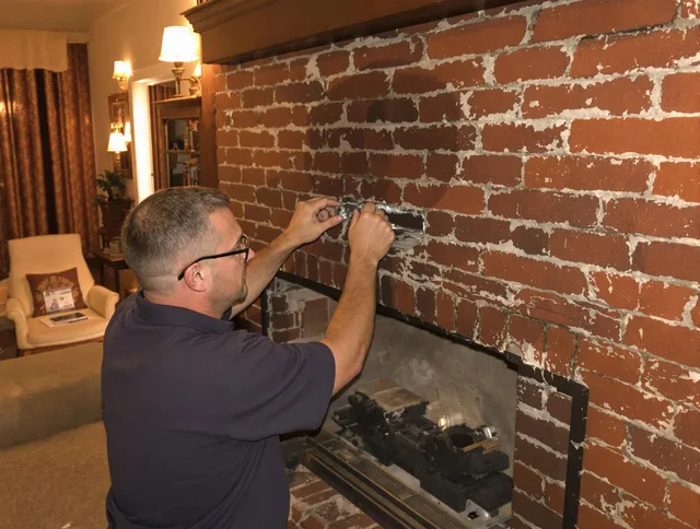 Central Falls Chimney Sweep expert fixing a fireplace in Central Falls, RI
